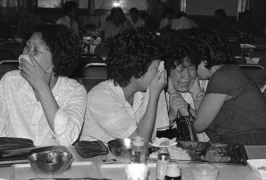 Sisters of Lee Chul-Kyu, a passenger on the Ill-fated Korean-Air Lines 747 jetliner, weep, Sept. 2, 1983, as South Korean government spokesman Lee Jin-Hie announced in Seoul, that it was “almost certain” the jetliner had been shot down en route to Seoul, South Korea. (AP Photo/Kim Chon-Kil)