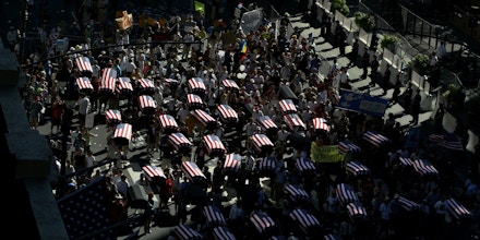 A group carrying what was described as 1,000 coffins representing the U.S. dead in Iraq marches past Madison Square Garden during the anti-Bush march organized by United for Peace and Justice in New York Sunday, August 29, 2004, on the eve of the Republican National Convention. (AP Photo/Ted Warren)