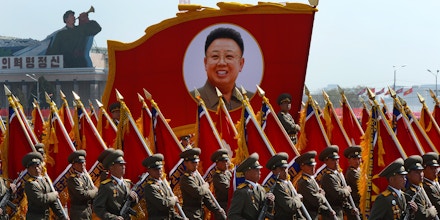 North Korean soldiers carry a portrait of late leader Kim Jong-Il during a military parade to mark 100 years since the birth of the country's founder Kim Il-Sung in Pyongyang on April 15, 2012. The commemorations came just two days after a satellite launch timed to mark the centenary fizzled out embarrassingly when the rocket apparently exploded within minutes of blastoff and plunged into the sea.    AFP PHOTO / PEDRO UGARTE (Photo credit should read PEDRO UGARTE/AFP/Getty Images)