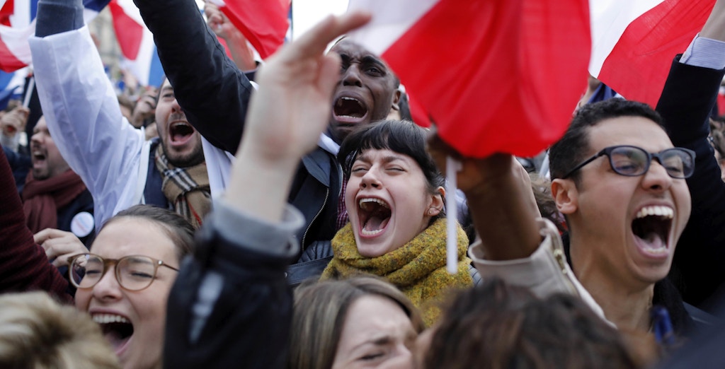 Supporters of French independent centrist presidential candidate, Emmanuel Macron react outside the Louvre museum in Paris, France, Sunday, May 7, 2017. Polling agencies have projected that centrist Emmanuel Macron will be France's next president, putting a 39-year-old political novice at the helm of one of the world's biggest economies and slowing a global populist wave. The agencies projected that Macron defeated far-right leader Marine Le Pen 65 percent to 35 percent on Sunday. (AP Photo/Laurent Cipriani)