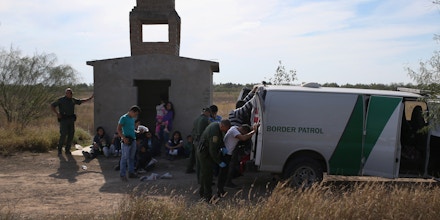 RIO GRANDE CITY, TX - DECEMBER 08:  Central American immigrants wait to be transported after turning themselves in to U.S. Border Patrol agents on December 8, 2015 near Rio Grande City, Texas. They had just illegally crossed the U.S.-Mexico border into Texas to seek asylum. The number of migrant families and unaccompanied minors has again surged in recent months, even as the total number of illegal crossings nationwide has gone down over the previous year.  (Photo by John Moore/Getty Images)