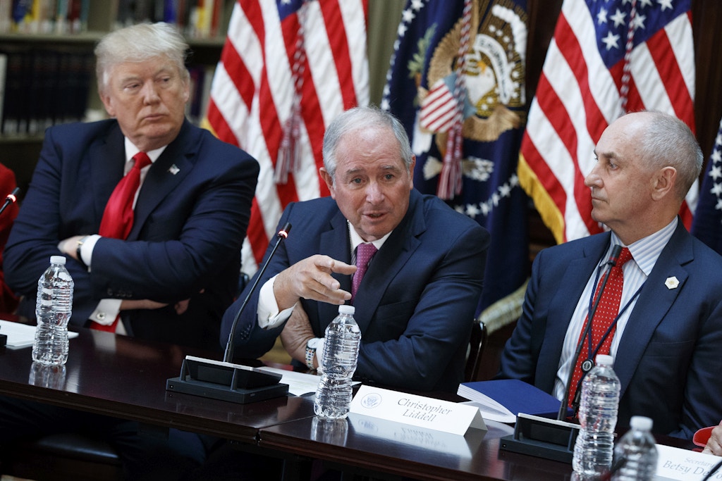 President Donald Trump, and Chris Liddell, the assistant to the president for strategic initiatives, right, listen as Blackstone Group CEO Stephen Schwarzman speaks during a meeting with business leaders in the State Department Library of the Eisenhower Executive Office Building on the White House complex in Washington, Tuesday, April 11, 2017. (AP Photo/Evan Vucci)