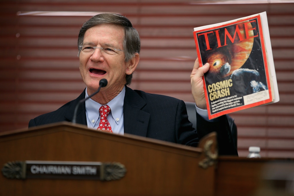 WASHINGTON, DC - MARCH 19:  House Science, Space and Technology Committee Chairman Lamar Smith (R-TX) holds up a copy of TIME Magazine with a cover article about 'near-Earth objects' during a hearing in the Rayburn House Office Building on Capitol Hill March 19, 2013 in Washington, DC. The committee asked government and military experts about efforts to track and mitigate asteroids and meteors.  (Photo by Chip Somodevilla/Getty Images)