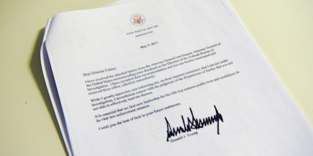 A copy of the termination letter to FBI Director James Comey from US President Donald Trump is seen at the White House on May 9, 2017 in Washington, DC.US President Donald Trump on Tuesday made the shock decision to fire his FBI director James Comey, the man who leads the agency charged with investigating his campaign's ties with Russia.The surprise dismissal of Comey, who played a controversial role in the 2016 presidential election, is sure to send shockwaves through Washington. / AFP PHOTO / MANDEL NGAN (Photo credit should read MANDEL NGAN/AFP/Getty Images)