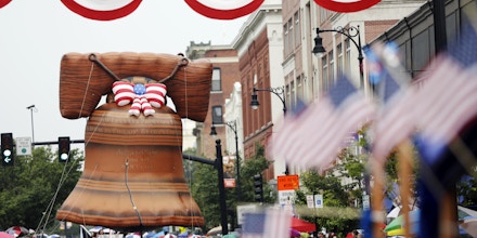 A Liberty Bell float looms high over spectators in the 2015 Fourth of July Parade in Pittsfield, Mass., on Saturday, July 4, 2015. (Stephanie Zollshan/The Berkshire Eagle via AP)