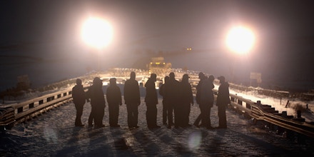 CANNON BALL, ND - DECEMBER 01:  Military veterans confront police guarding a bridge near Oceti Sakowin Camp on the edge of the Standing Rock Sioux Reservation on December 1, 2016 outside Cannon Ball, North Dakota. Native Americans and activists from around the country have been gathering at the camp for several months trying to halt the construction of the Dakota Access Pipeline. The proposed 1,172-mile-long pipeline would transport oil from the North Dakota Bakken region through South Dakota, Iowa and into Illinois.  (Photo by Scott Olson/Getty Images)