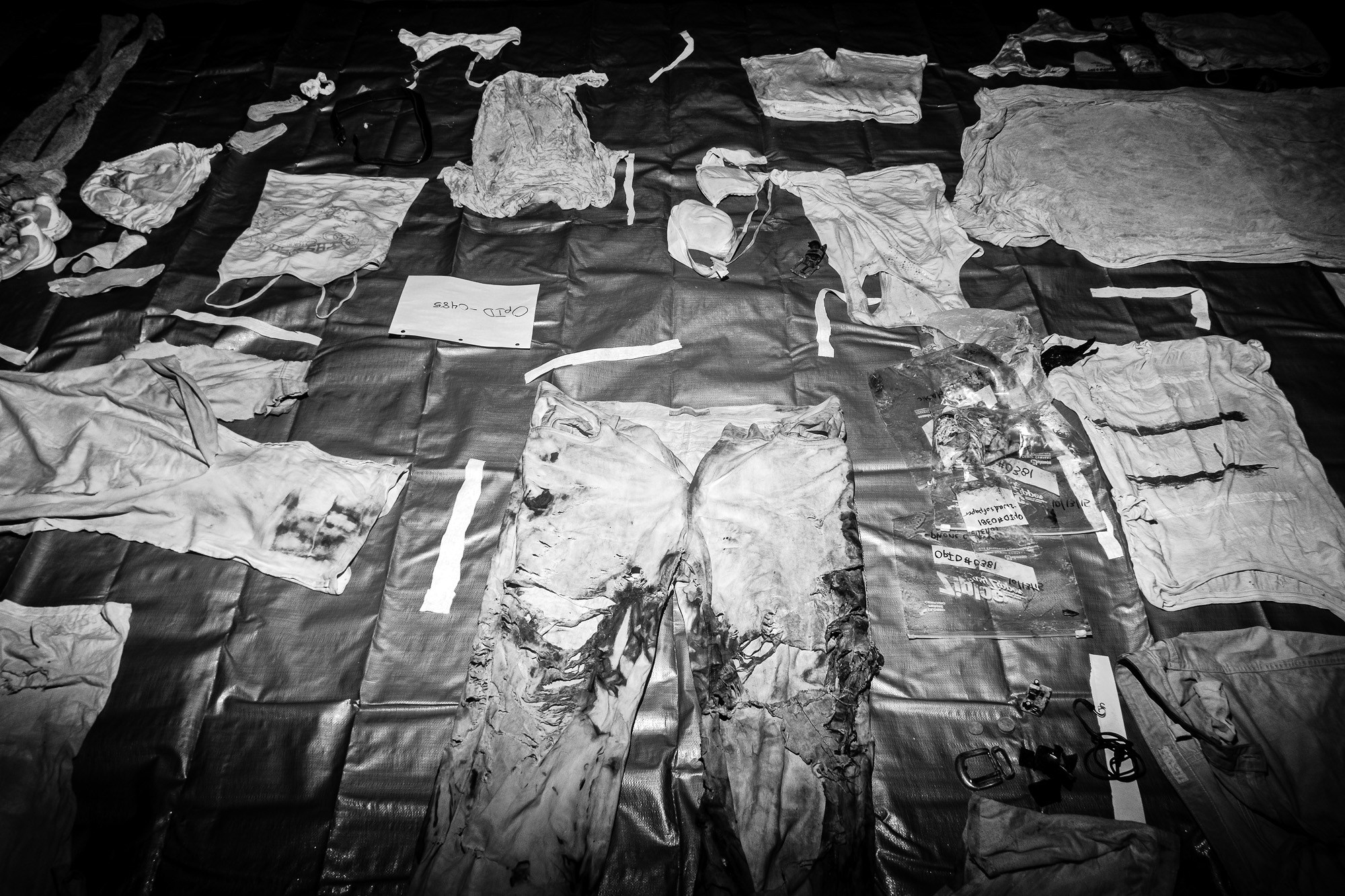 Clothing and personal effects recovered with the remains of unidentified suspected migrants dry on the floor of Texas State University’s Osteological Research and Processing Laboratory (ORPL) in San Marcos, Texas, January 14, 2016. These items will be cataloged and investigated as part of Operation Identification (OpID), an effort to identify and repatriate bodies recovered along migration routes near the US-Mexico border.