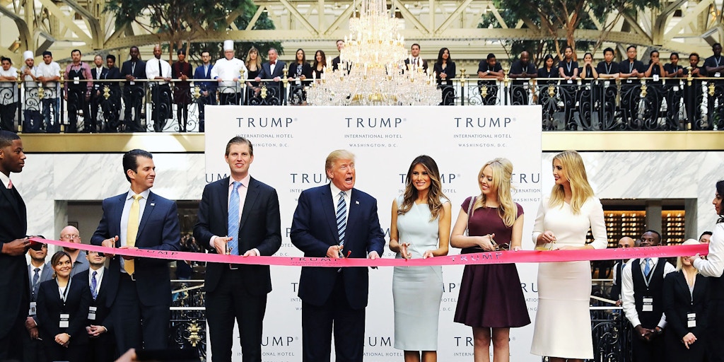WASHINGTON, DC - OCTOBER 26:  Republican presidential nominee Donald Trump (C) and his family (L-R) son Donald Trump Jr, son Eric Trummp, wife Melania Trump and daughters Tiffany Trump and Ivanka Trump cut the ribbon at the new Trump International Hotel October 26, 2016 in Washington, DC. The hotel, built inside the historic Old Post Office, has 263 luxry rooms, including the 6,300-square-foot 'Trump Townhouse' at $100,000 a night, with a five-night minimum. The Trump Organization was granted a 60-year lease to the historic building by the federal government before the billionaire New York real estate mogul announced his intent to run for president.  (Photo by Chip Somodevilla/Getty Images)