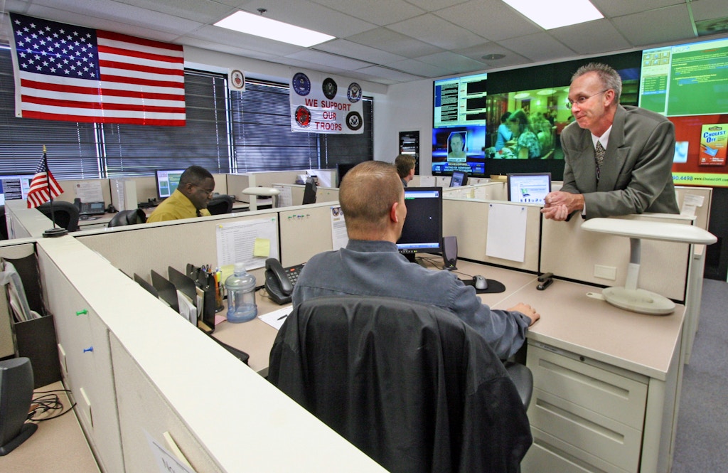 UNITED STATES - NOVEMBER 02:  Maryland state "fusion center," where federal and local officials share info about possible terrorist activities. Photo taken in the Watch Center where all terrorism and suspicious calls are routed. On the right is Jeffrey L. Wobbleton, Maryland Coordination and Analysis Center Watch Commander speaking with one of the working specialists.  (Photo by Robert A. Reeder/Washington Post/Getty Images)