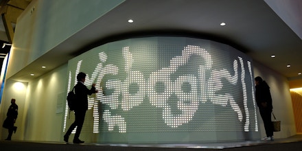 Two people visit the stand of Google on the second day of the Mobile World Congress on February 28, 2017 in Barcelona.Phone makers will seek to seduce new buyers with artificial intelligence functions and other innovations at the world's biggest mobile fair starting today in Spain. / AFP / LLUIS GENE (Photo credit should read LLUIS GENE/AFP/Getty Images)