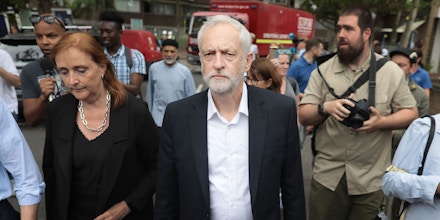 LONDON, ENGLAND - JUNE 15:  Labour leader Jeremy Corbyn visits the scene of the Grenfell Tower fire with new Labour MP for Kensington, Emma Dent Coad (L), on June 15, 2017 in London, England. At least 17 people have been confirmed dead and dozens missing, after the 24 storey residential Grenfell Tower block in Latimer Road was engulfed in flames in the early hours of June 14. The number of fatalities are expected to rise.  (Photo by Jack Taylor/Getty Images)