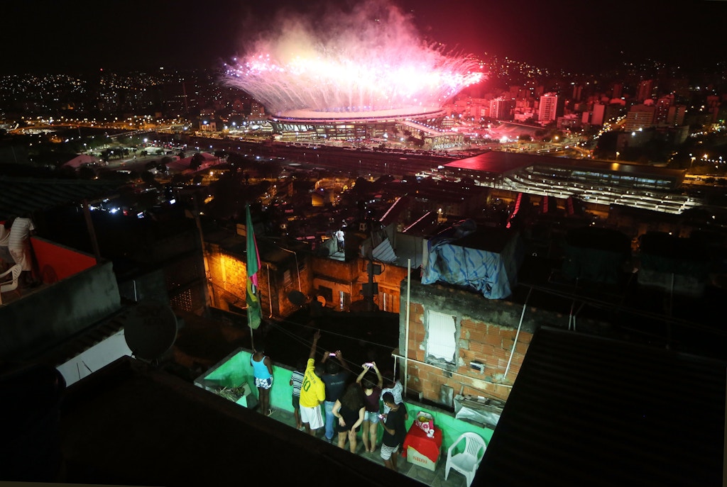 RIO DE JANEIRO, BRAZIL - AUGUST 05: Fireworks explode over Maracana stadium with the Mangueira 'favela' community in the foreground during opening ceremonies for the Rio 2016 Olympic Games on August 5, 2016 in Rio de Janeiro, Brazil. The Rio 2016 Olympic Games commenced tonight at the iconic stadium. (Photo by Mario Tama/Getty Images)