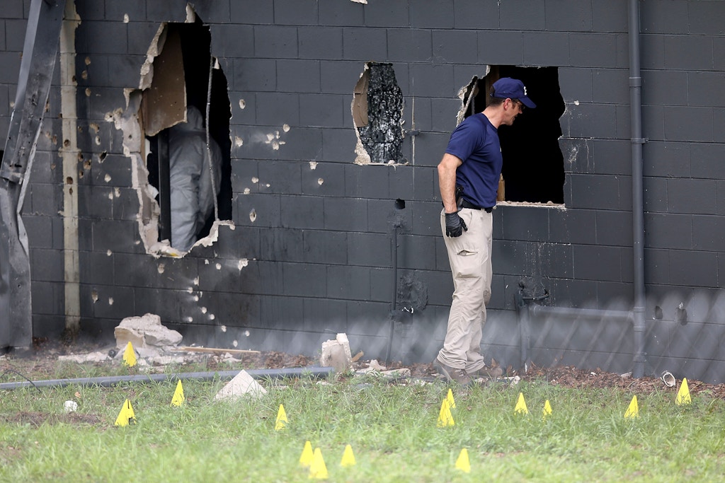 ORLANDO, FL - JUNE 12:  FBI agents investigate the damaged rear wall of the Pulse Nightclub where Omar Mateen allegedly killed at least 50 people on June 12, 2016 in Orlando, Florida. The mass shooting killed at least 50 people and injured 53 others in what is the deadliest mass shooting in the country's history.  (Photo by Joe Raedle/Getty Images)