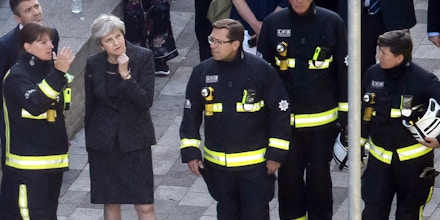 LONDON, ENGLAND - JUNE 15:  Prime Minister Theresa May speaks to Dany Cotton, Commissioner of the London Fire Brigade, with members of the fire service as she visits Grenfell Tower, on June 15, 2017 in London, England. At least twelve people have been confirmed dead and dozens missing, after the 24 storey residential Grenfell Tower block in Latimer Road was engulfed in flames in the early hours of June 14. The number of fatalities are expected to rise.  (Photo by Dan Kitwood/Getty Images)