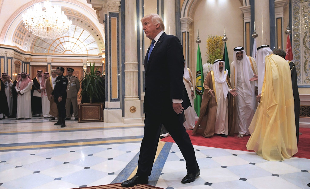 US President Donald Trump (C) walks away after posing for a group picture with leaders of the Gulf Cooperation Council in Riyadh on May 21, 2017. / AFP PHOTO / MANDEL NGAN        (Photo credit should read MANDEL NGAN/AFP/Getty Images)