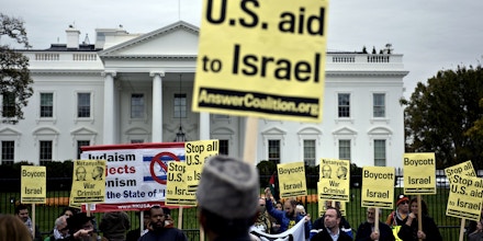 Demonstrators march to protest the visit of Israeli Prime Minister Benjamin Netanyahu in front of the White House November 9, 2015 in Washington, DC. Netanyahu meets US President Barack Obama in Washington Monday in a bid to set aside their frosty personal ties, turn the page on the Iran nuclear deal and talk defense. AFP PHOTO/BRENDAN SMIALOWSKI        (Photo credit should read BRENDAN SMIALOWSKI/AFP/Getty Images)