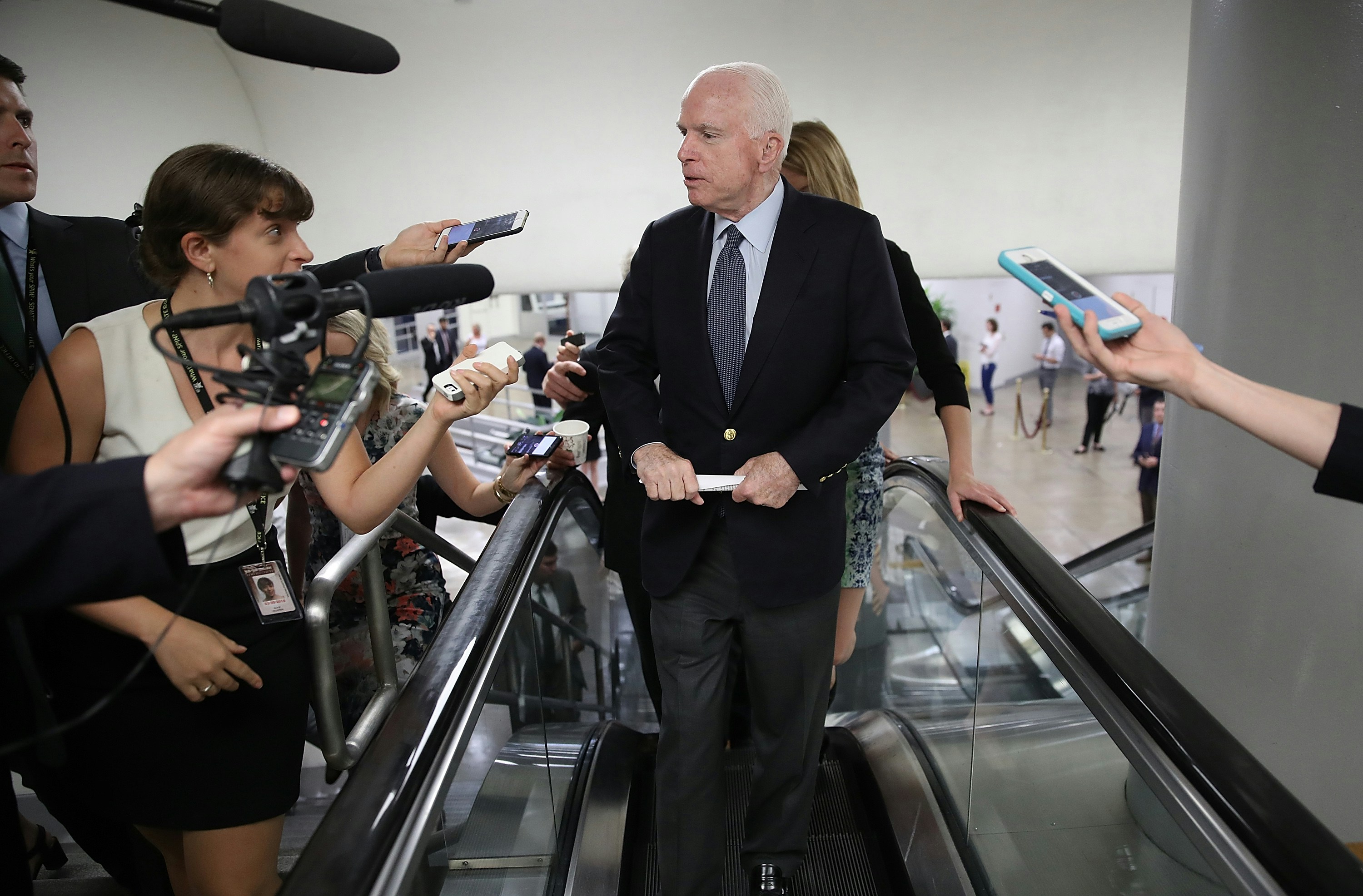 WASHINGTON, DC - JULY 13:  Sen. John McCain (R-AZ) answers questions from reporters as he walks to a meeting of Republican senators where a new version of their healthcare bill was scheduled to be released at the U.S. Capitol July 13, 2017 in Washington, DC. The latest version of the proposed bill aims to repeal and replace the Affordable Care Act, also knows as Obamacare.  (Photo by Win McNamee/Getty Images)