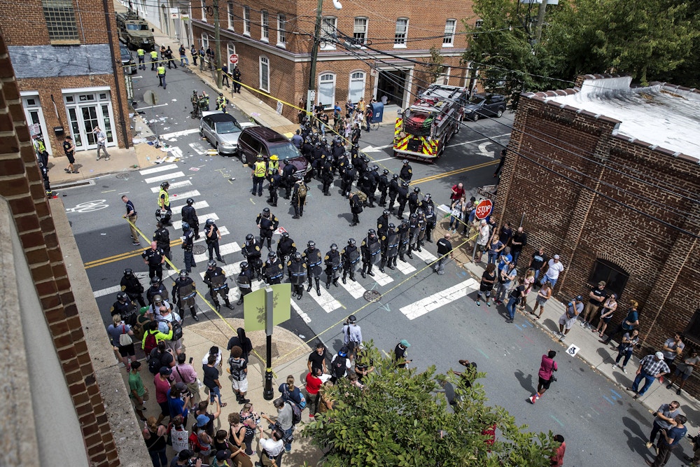 CHARLOTTESVILLE, USA - August 12: Police, medical personnel, and other protestors attend to the injured people after a car rammed into a crowd of anti-White Supremacy protestors in Charlottesville, Va., USA on August 12, 2017. (Photo by Samuel Corum/Anadolu Agency/Getty Images)