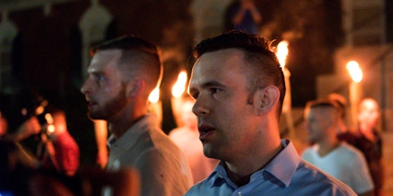 Evan McLaren acts as one of the leaders of a torch march by 