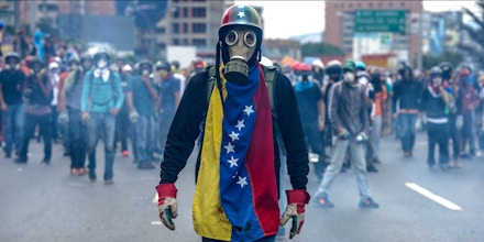 TOPSHOT - Opposition activists protest against President Nicolas Maduro, in Caracas on May 8, 2017.Venezuela's opposition mobilized Monday in fresh street protests against President Nicolas Maduro's efforts to reform the constitution in a deadly political crisis. Supporters of the opposition Democratic Unity Roundtable (MUD) gathered in eastern Caracas to march to the education ministry under the slogan 