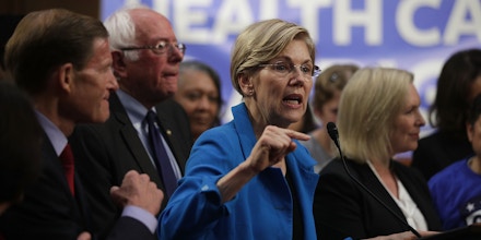 WASHINGTON, DC - SEPTEMBER 13:  U.S. Sen. Elizabeth Warren (D-MA) (C) speaks on health care as Sen. Bernie Sanders (I-VT) (2nd L) listens during an event September 13, 2017 on Capitol Hill in Washington, DC. Sen. Sanders held an event to introduce the Medicare for All Act of 2017.  (Photo by Alex Wong/Getty Images)