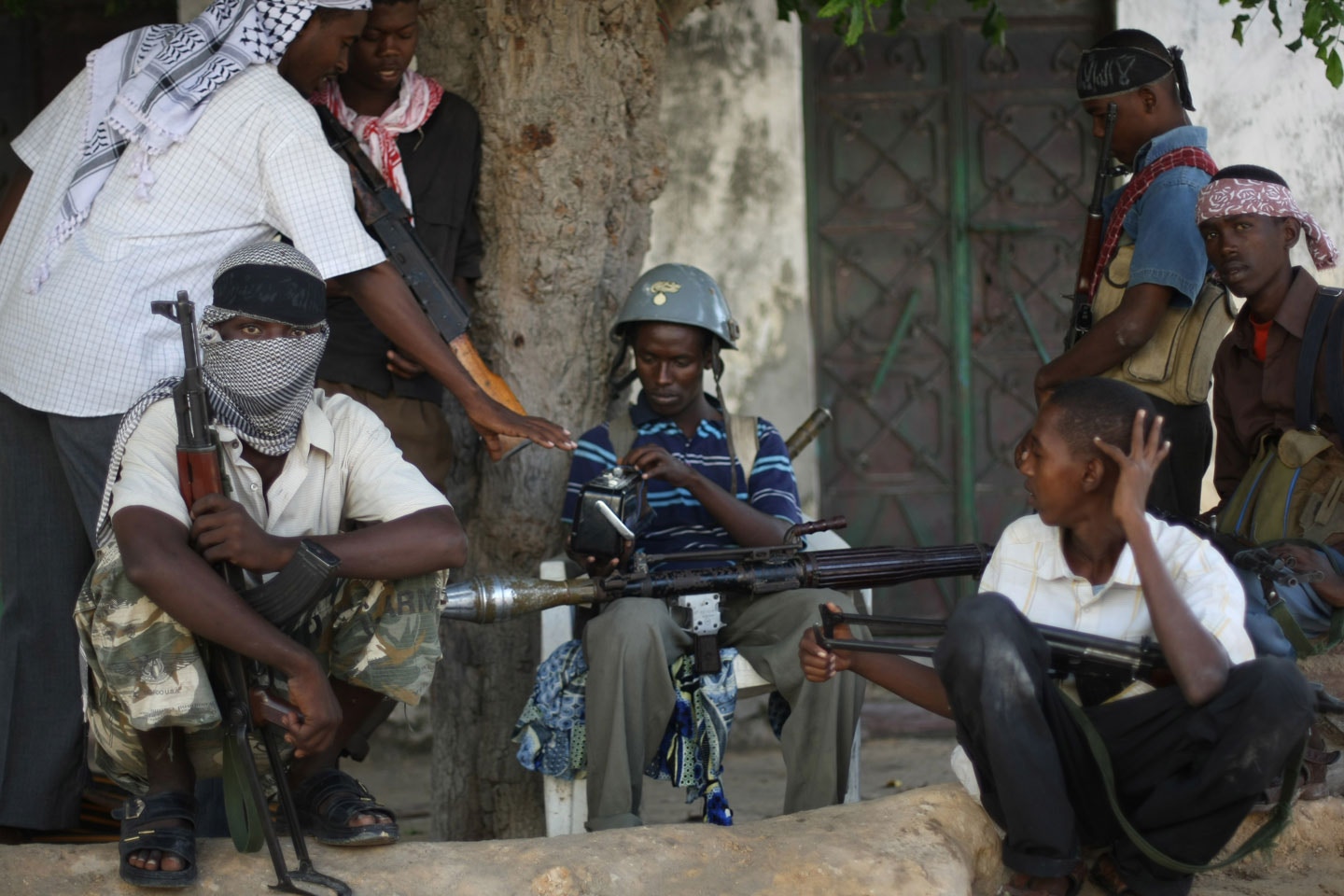 Al-Shabab and Hizbul Islam militants take a break at a front-line section in sanca district in Mogadishu,  on July 21, 2009. Somalia's hard line Shabab militia yesterday raided the offices of three UN organisations hours after they banned their operations on accusation that they were "enemies of Islam and Muslims. The armed group stormed the United Nations Development Programme, UN Department of Safety and Security and the UN Political Office for Somalia in two southern Somalia towns and impounded office equipment. The above foreign agencies have been found to be working against the benefit of the Somali Muslim population and against the establishment of an Islamic state in Somalia," the Shebab said in a statement. AFP PHOTO/ MOHAMED DAHIR        (Photo credit should read MOHAMED DAHIR/AFP/GettyImages)