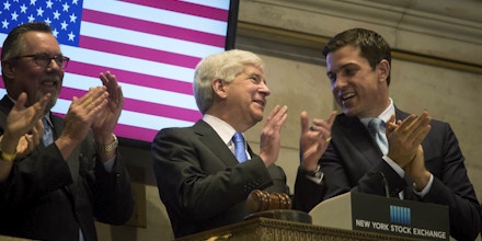 Steve Arwood, chief executive officer of the Michigan Economic Development Corp., from left, Rick Snyder, governor of Michigan, and Thomas Farley, president of NYSE Group Inc., ring the opening bell at the New York Stock Exchange (NYSE) in New York, U.S., on Friday, May 8, 2015. U.S. stocks rose after a rebound in hiring last month bolstered optimism that economic growth is accelerating, but not fast enough to warrant higher interest rates in June. Photographer: Michael Nagle/Bloomberg via Getty Images
