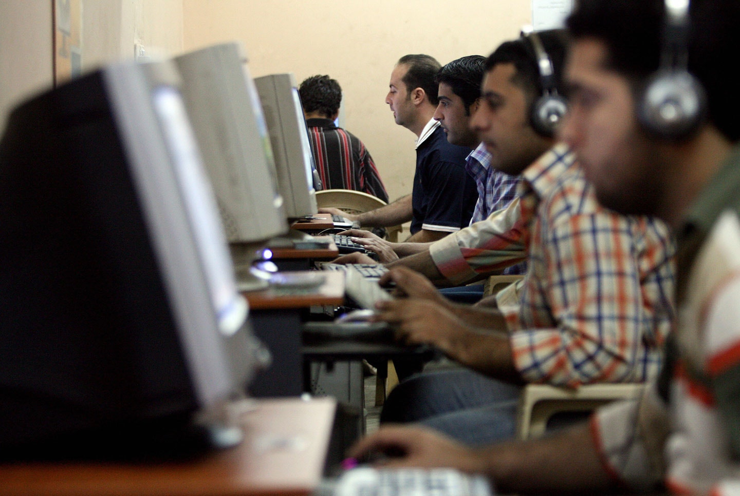 Iraqi youth surf the web at an internet cafe in Baghdad's impoverished district of Sadr city, 15 November 2007. Iraqi youth are spending more time on the internet; following local and international news or chatting with far away friends as they try to escape their bitter reality by staying in connection with the outside world through the virtual world of the internet. AFP PHOTO/ALI AL-SAADI (Photo credit should read ALI AL-SAADI/AFP/Getty Images)