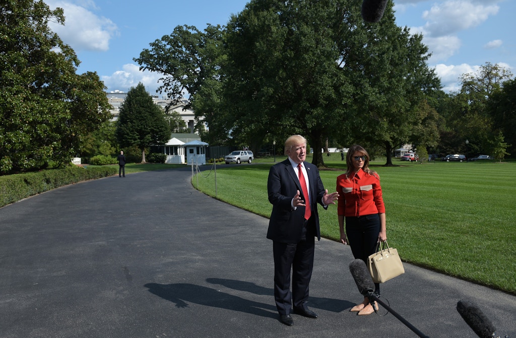 US President Donald Trump speaks about Hurricane Irma watched by First Lady Melania Trump upon return to the White House in Washington, DC on September 10, 2017.<br /><br />
Trump returned to Washington after spending the weekend at the Camp David presidential retreat. / AFP PHOTO / MANDEL NGAN        (Photo credit should read MANDEL NGAN/AFP/Getty Images)