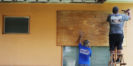 MIAMI, FL - SEPTEMBER 06:  People put up shutters as they prepare a family members house for Hurricane Irma on September 6, 2017 in Miami, Florida. It's still too early to know where the direct impact of the hurricane will take place but the state of Florida is in the area of possible landfall.  (Photo by Joe Raedle/Getty Images)