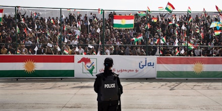SULAIMANIYAH, IRAQ: A female riot police officer watches the crowd at the Sulaimaniyah Stadium during a pro-independence rally.Iraqi Kurdish president, Masoud Barzani, has called for a referendum on Kurdish independence for September 25th. It is opposed by the central Iraqi government and many external countries including the US.Photo by Sebastian Meyer