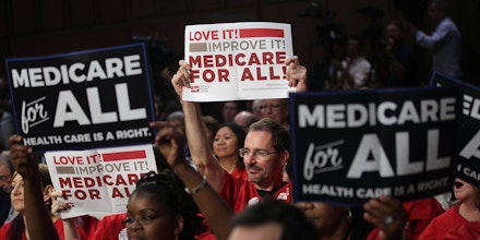 WASHINGTON, DC - SEPTEMBER 13:  Supporters of U.S. Sen. Bernie Sanders (I-VT) hold signs during an event on health care September 13, 2017 on Capitol Hill in Washington, DC. Sen. Sanders held an event to introduce the Medicare for All Act of 2017.  (Photo by Alex Wong/Getty Images)