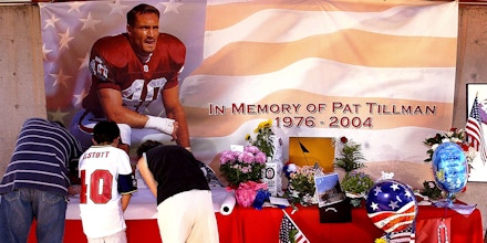 Fans sign a memorial for former Arizona Cardinal and U.S. Army Ranger Pat Tillman Friday, April 23, 2004 at the Cardinals training facility in Tempe, Ariz. Tillman was killed in Afghanistan after walking away from a multimillion-dollar NFL contract to join the Army Rangers, U.S. officials said Friday. Tillman played four seasons with the Cardinals before enlisting in the Army in May 2002. The safety turned down a three-year, $3.6 million deal from Arizona. (AP Photo/Matt York)