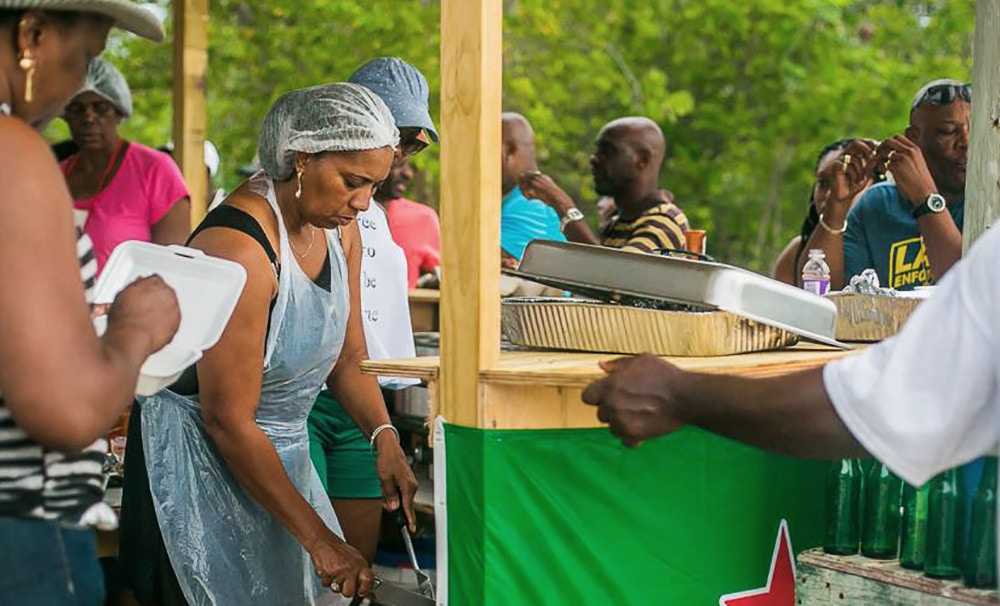 Anguilla locals prepare and enjoy a Caribbean cookout at the 2016 West fest along Meads Bay, Anguilla on August 04, 2016.