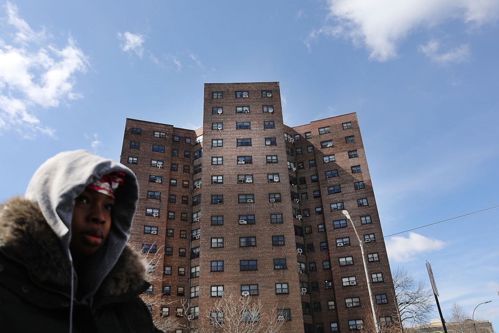 NEW YORK, NY - MARCH 16:  A woman walks by the Farragut Houses, a public housing project in Brooklyn on  March 16, 2017 in New York City.The budget blueprint President Donald Trump released Thursday calls for  the cutting of billions of dollars in funding from the Department of Housing and Urban Development. This is despite a campaign pledge Trump made to help rebuild the nation's inner city communities.  (Photo by Spencer Platt/Getty Images)