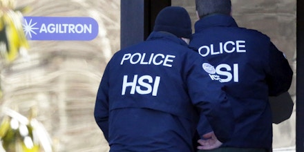 Agents from the U.S. Immigration and Customs Enforcement's Homeland Security Investigations (HSI) unit enter the offices of Agiltron in Woburn, Massachusetts, U.S., on Wednesday, Jan. 23, 2013. Agiltron describes itself as providing clients with 
