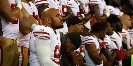 INDIANAPOLIS, IN - OCTOBER 08: Xavier Cooper #96 of the San Francisco 49ers and other members of the team kneel during the National Anthem before the game against the Indianapolis Colts at Lucas Oil Stadium on October 8, 2017 in Indianapolis, Indiana.  (Photo by Bobby Ellis/Getty Images)