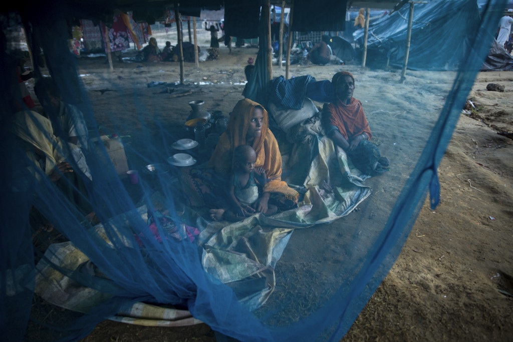 KUTUPALONG, BANGLADESH - SEPTEMBER 29: Women are seen behind a mosquito net September 29 in Kutupalong refugee camp, Bangladesh. Over a half a million Rohingya refugees have fled into Bangladesh from the horrific violence in Rakhine state in Myanmar causing a humanitarian crisis. (Photo by Paula Bronstein/Getty Images)