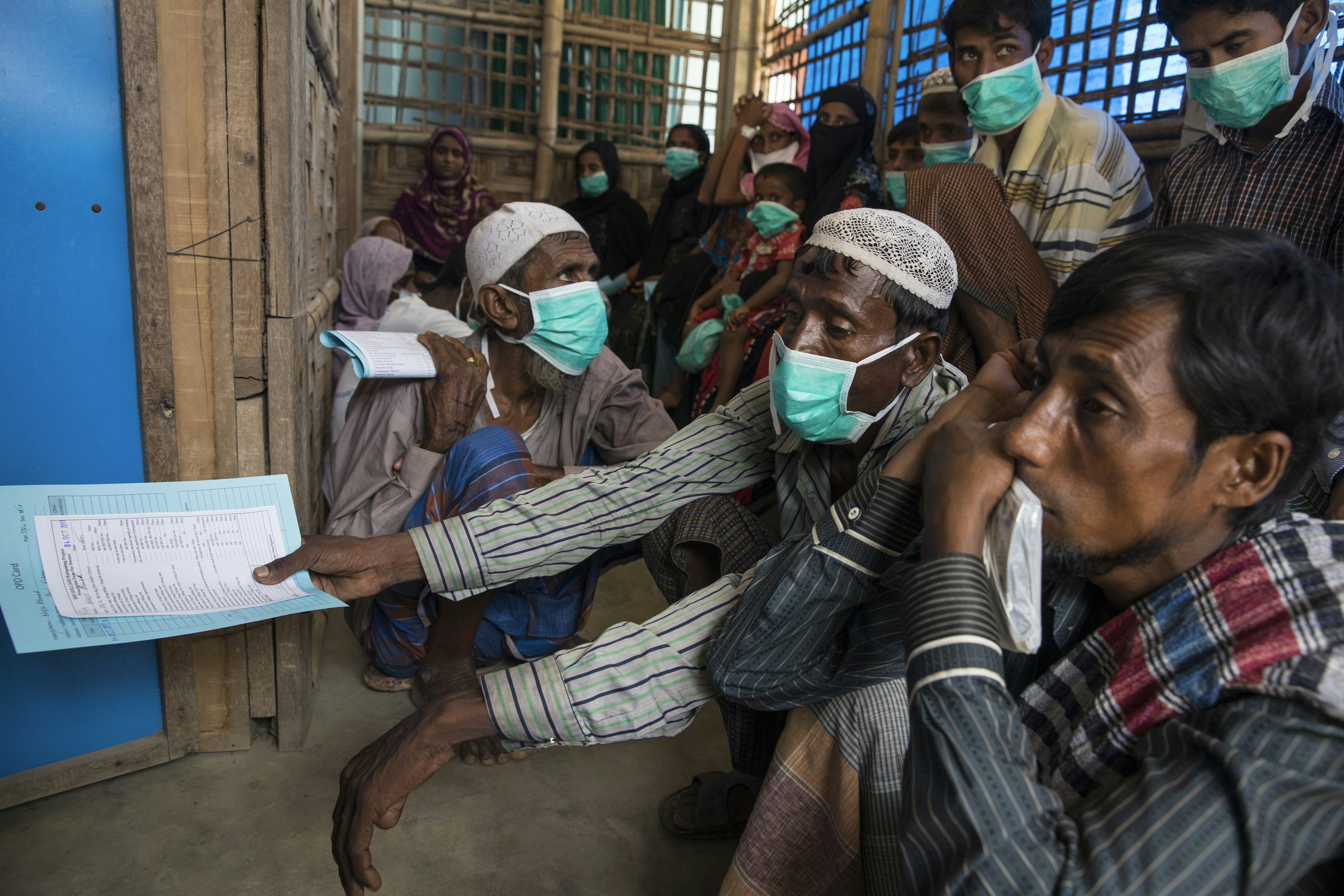 KUTUPALONG, BANGLADESH - OCTOBER 4: Patients wait for testing and medical treatment for tuberculosis at the 'Doctors Without Borders' Kutupalong clinic on October 4, 2017 in Cox's Bazar, Bangladesh. Doctors Without Borders has been providing comprehensive basic healthcare services at their Kutupalong clinic since 2009. Due to the current Rohingya crisis, the clinic has expanded it's inpatient capacity dealing with approximately 2,500 out patient treatments and around 1,000 emergency room patients per week. All healthcare services provided at the clinic are free of charge to both the Rohingya refugee population as well as local Bangladeshi patients. Doctors Without Borders has also set up a number of health posts, mobile clinics and water and sanitation services elsewhere in Cox's Bazar to better respond to the influx. Well over a half a million Rohingya refugees have fled into Bangladesh since late August during the outbreak of violence in Rakhine state causing a humanitarian crisis in the region with continued challenges for aid agencies. (Photo by Paula Bronstein/Getty Images)