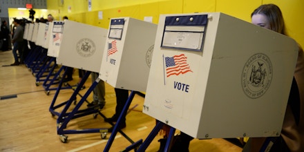 People vote for the next US president in the general election at a polling station in a school gymnasium in New York, November 8, 2016.Polling stations opened Tuesday as the first ballots were cast in the long-awaited election pitting Hillary Clinton against Donald Trump. / AFP / Robyn Beck (Photo credit should read ROBYN BECK/AFP/Getty Images)