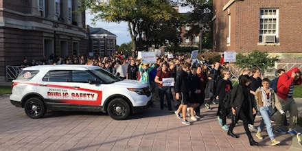Hundreds of protesters break through a fence set up by administrators at Rensselaer Polytechnic Institute to contain an October 13, 2017. 