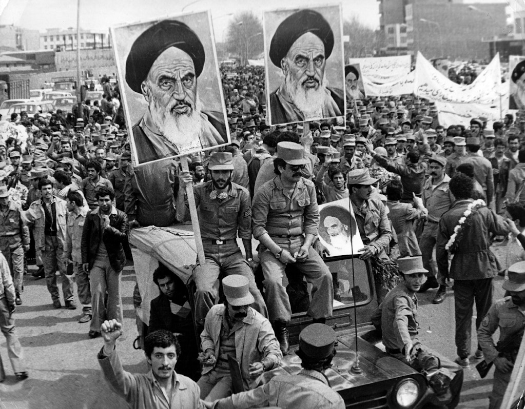 The Iranian Islamic Republic Army demonstrates in solidarity with people in the street during the Iranian revolution. They are carrying posters of the Ayatollah Khomeini, the Iranian religious and political leader.   (Photo by Keystone/Getty Images)