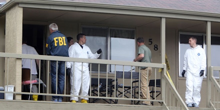 Federal authorities search an apartment in Boise, Idaho on Cassia Drive on Thursday afternoon, May 16 2013. U.S. authorities in Idaho said they have arrested a man from Uzbekistan accused of conspiring with a designated terrorist organization in his home country and helping scheme to use a weapon of mass destruction. Fazliddin Kurbanov, 30, was arrested at an apartment complex in south Boise on Thursday morning after a grand jury issued a three-count indictment as part of an investigation into his activities in Idaho and Utah. (AP Photo/The Idaho Statesman, Joe Jaszewski)