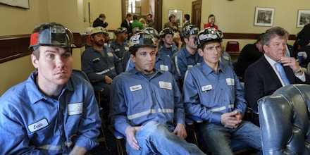 Coal miners listen to speakers during an Environmental Protection Agency public hearing, Tuesday, Nov. 28, 2017, at the state Capitol in Charleston, W.Va. The EPA was taking comments Tuesday and Wednesday on its proposed repeal of the Clean Power Plan, an Obama-era plan to limit planet-warming carbon emissions. (Chris Dorst/Charleston Gazette-Mail via AP)