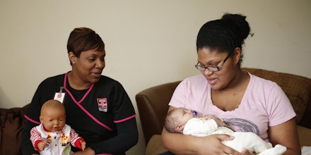 ADVANCE FOR THE WEEKEND OF APRIL 13-14 AND THEREAFTER - TeShawn Cabbil Hobson, left, a nurse with Easter Seals, visits with Jessica Scrivner, right, and her 4-week-old son Aiden at the Scrivner's apartment in Tuscaloosa, Ala. on Thursday, April 4, 2013. Easter Seals of West Alabama is now offering a nurse-family partnership program where nurses are paired with financially-struggling expectant mothers. The nurses meet with the moms as often as once a week for the first two years of their child's life to help educate them about parenting a young child and help them set educational and financial goals. (AP Photo/The Tuscaloosa News, Robert Sutton)  (Robert Sutton / Tuscaloosa News)