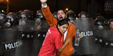 Supporters of Honduran presidential candidate for the Opposition Alliance against the Dictatorship party Salvador Nasralla, are affected by tear gas during a protest outside the Electoral Supreme Court (TSE), to demand the announcement of the election final results in Tegucigalpa, on November 30, 2017. Honduran opposition candidate Salvador Nasralla said he would not recognize the results to be announced by the Supreme Electoral Tribunal, after accusing it of tampering with the vote count to favor the reelection of President Juan Orlando Hernandez. / AFP PHOTO / ORLANDO SIERRA (Photo credit should read ORLANDO SIERRA/AFP/Getty Images)