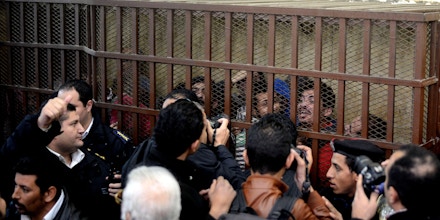 Defendants react behind the bars at a court in Cairo following the acquittal on January 12, 2015 of 26 male men accused of 
