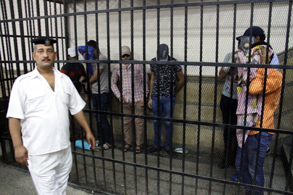 CAIRO, EGYPT - NOVEMBER 01: Eight people sentenced to three years in jail after joining an illegal gay wedding ceremony are seen behind the bars in Cairo, Egypt, on November 1, 2014. The men were found guilty of spreading "indecent images" and "inciting debauchery" over a video that appeared to show them celebrating a gay marriage in Cairo. (Photo by Stringer/Anadolu Agency/Getty Images)