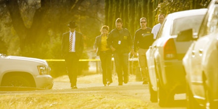 FBI agents are seen behind yellow crime scene tape outside Rancho Tehama Elementary School after a shooting in the morning on November 14, 2017, in Rancho Tehama, CaliforniaFour people were killed and nearly a dozen were wounded, including several children, when a gunman went on a rampage at multiple locations, including a school in rural northern California. / AFP PHOTO / Elijah Nouvelage (Photo credit should read ELIJAH NOUVELAGE/AFP/Getty Images)