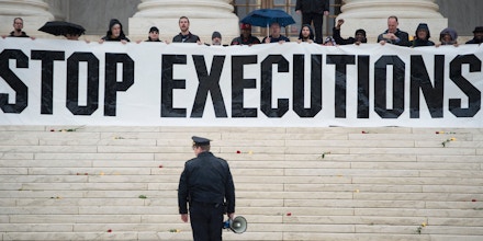 A police officer warns activists to leave during an anti death penalty protest in front of the US Supreme Court January 17, 2017 in Washington, DC. / AFP / Brendan Smialowski        (Photo credit should read BRENDAN SMIALOWSKI/AFP/Getty Images)